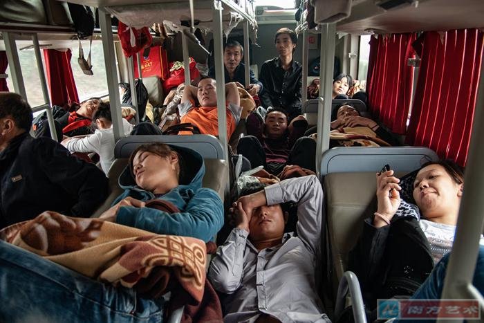 Zhan Youbing: Workers riding a long-distance bus, Dongguan, China (2011)